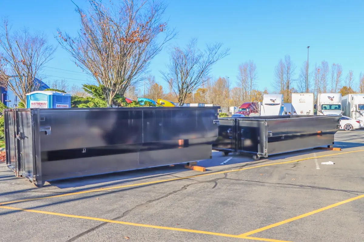 Professional dumpster rental service with roll-off container on residential driveway in Cedarburg